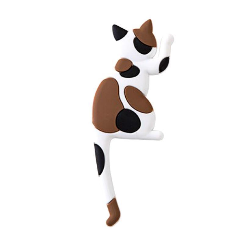 Cat-shaped stress reliever toy with brown and black spots on a white background