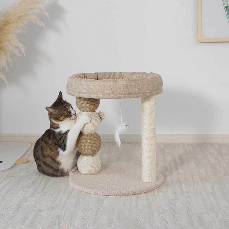 Cat playing with a cat tree in a room with a white wall and wooden floor neferpaws