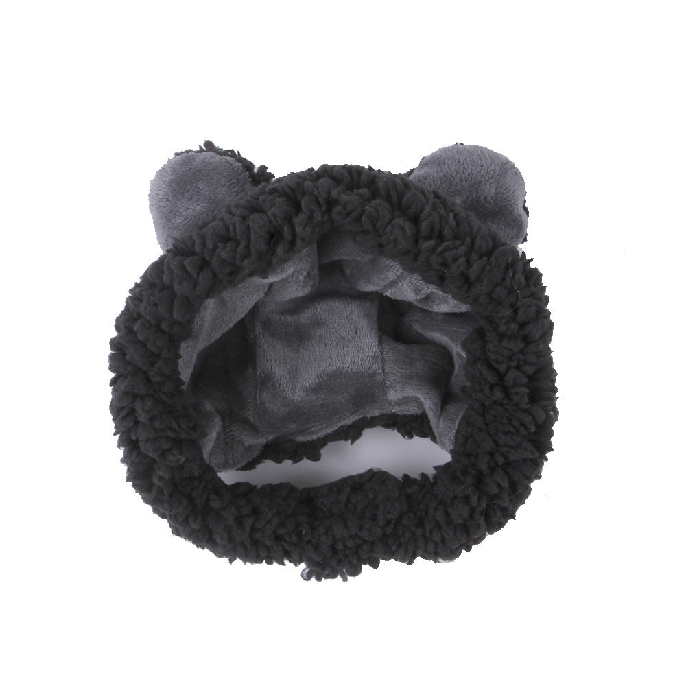 Black fuzzy headband with cat ears on a white background
