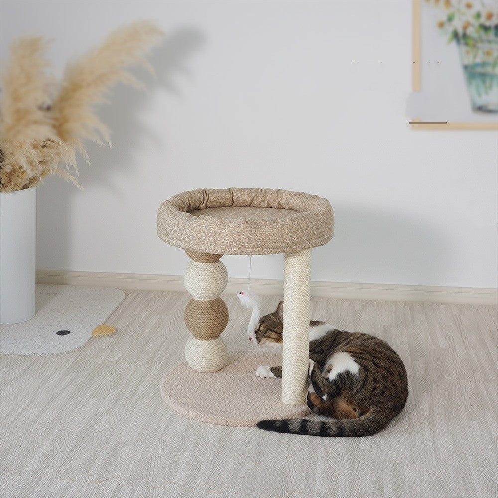 Cat playing on a multi-level cat tree in a room with a plant and rug - Neferpaws