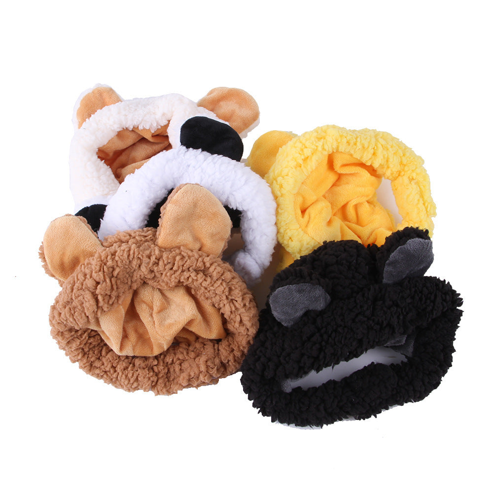 Set of four plush animal paw toys in different colors on a white background