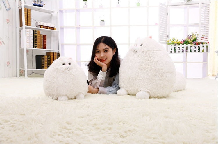 Woman posing with two large white plush toys in a bright room - Neferpaws
