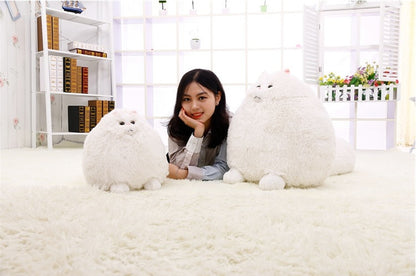 Woman posing with two large white plush toys in a bright room - Neferpaws