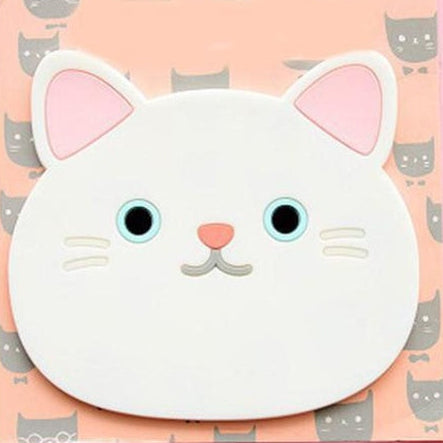 White cat shapd coaster staring into nothing