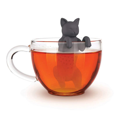 Cat-shaped tea infuser in a glass of red tea 