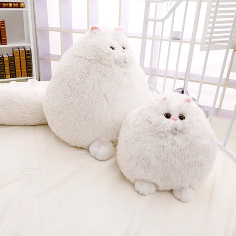 Two fluffy white cat-shaped plush toys on a light surface with - Neferpaws