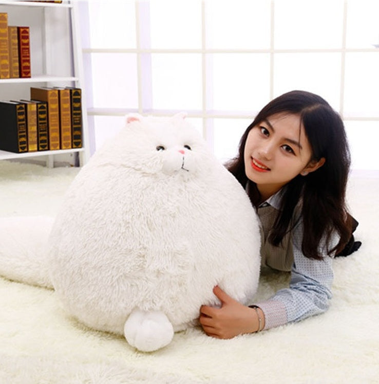 Person holding a large white fluffy toy in a room with a bookshelf - Neferpaws