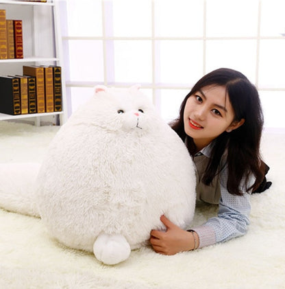 Person holding a large white fluffy toy in a room with a bookshelf - Neferpaws