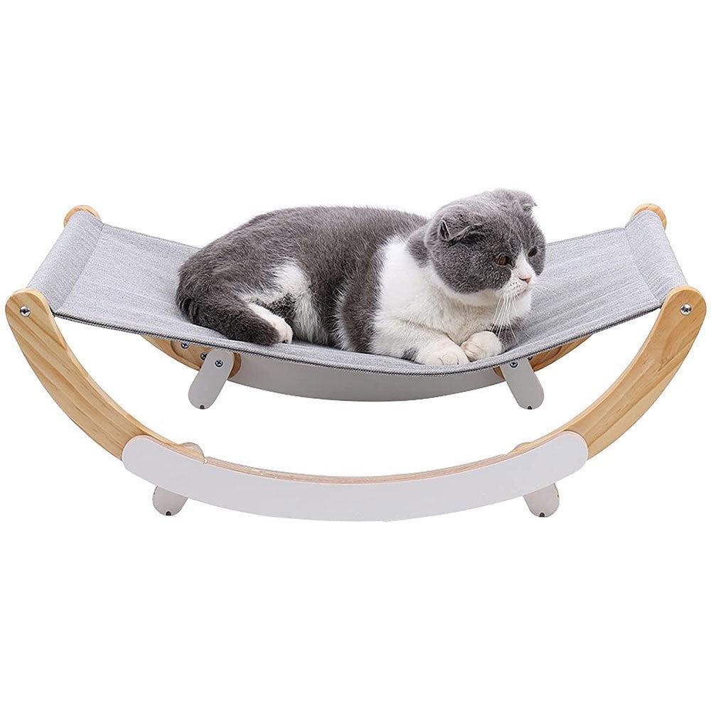 Cat lying on a gray hammock with wooden frame against a white background
