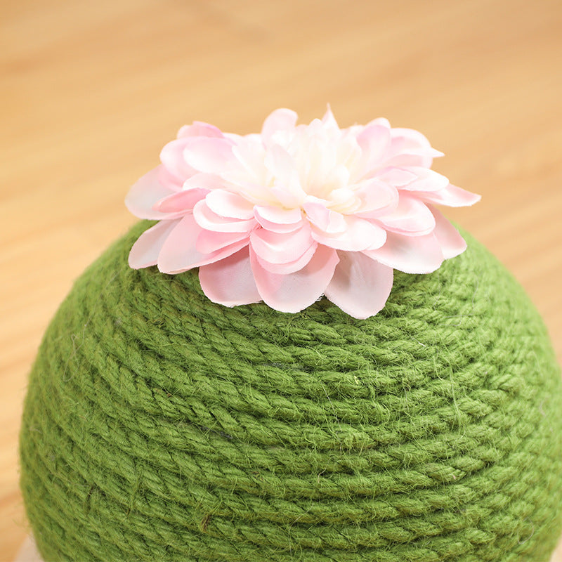 Green scratching ball with a white flower