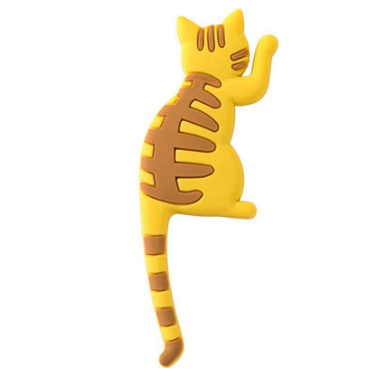 Yellow cat-shaped object with brown stripes on a white background