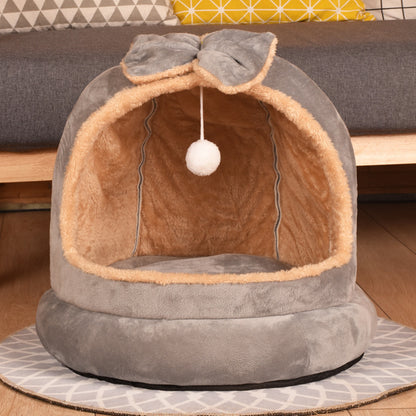 Cat bed with a bow and hanging ball on a wooden floor - Neferpaws