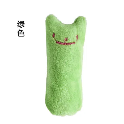 Green plush toy with a smiley face on a white background