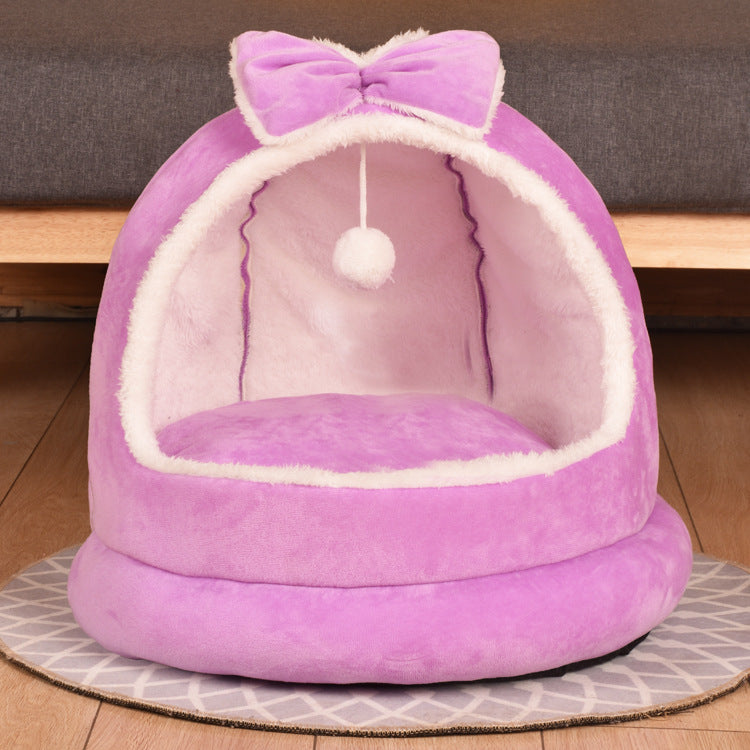 Purple cat bed with a bow and pom-pom on a wooden floor - Neferpaws