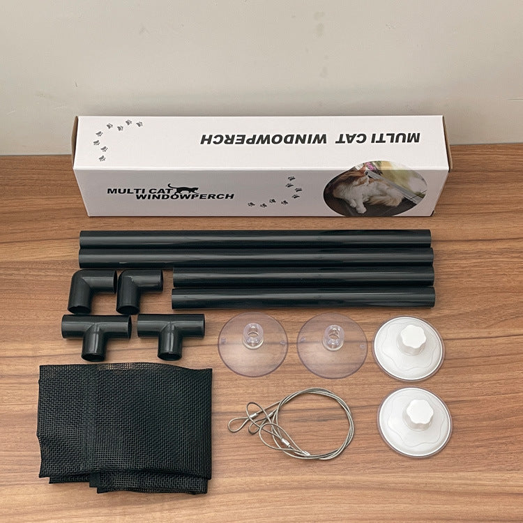 Multicat window perch components on a wooden surface with packaging.