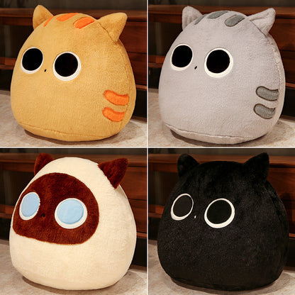 Four plush toys in different colors with large eyes on a wooden surface.